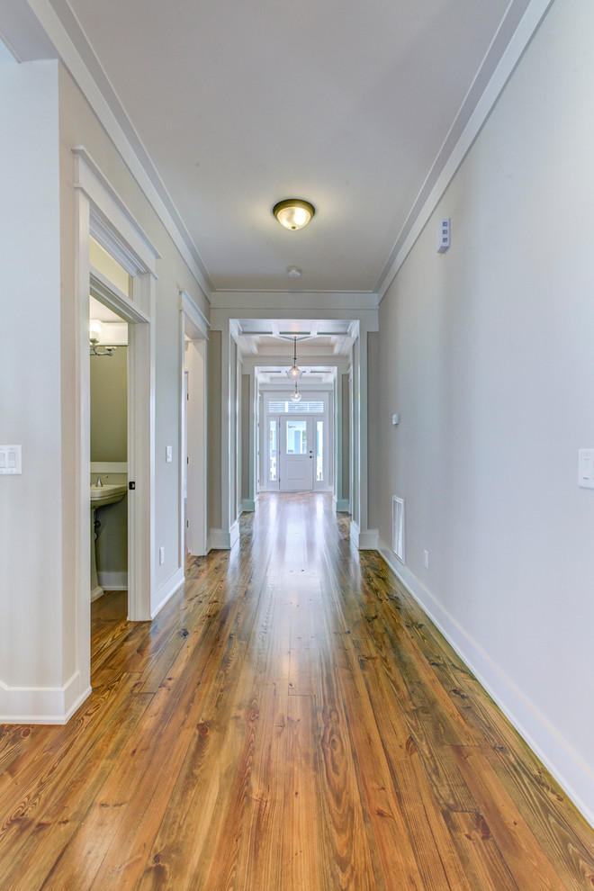 Design ideas for a mid-sized country hallway in Raleigh with grey walls and medium hardwood floors.
