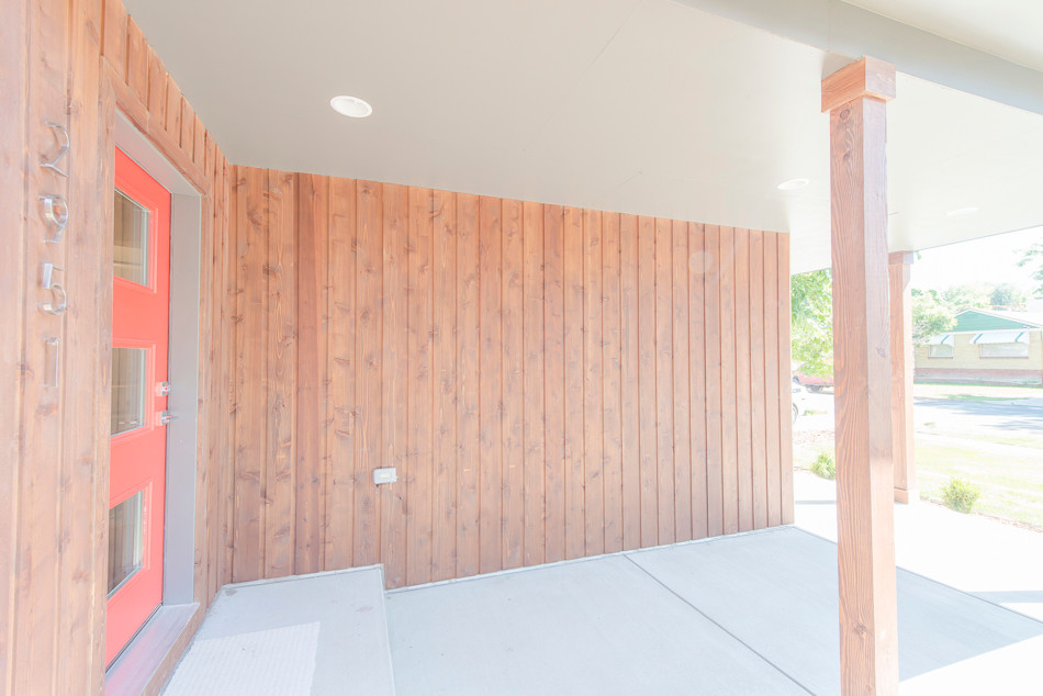 Front door - mid-sized transitional concrete floor front door idea in Denver with brown walls and a red front door