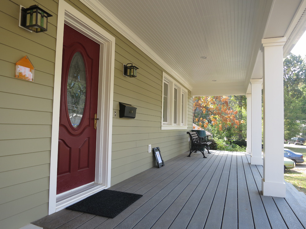 Mid-sized country front yard verandah in DC Metro with decking and a roof extension.