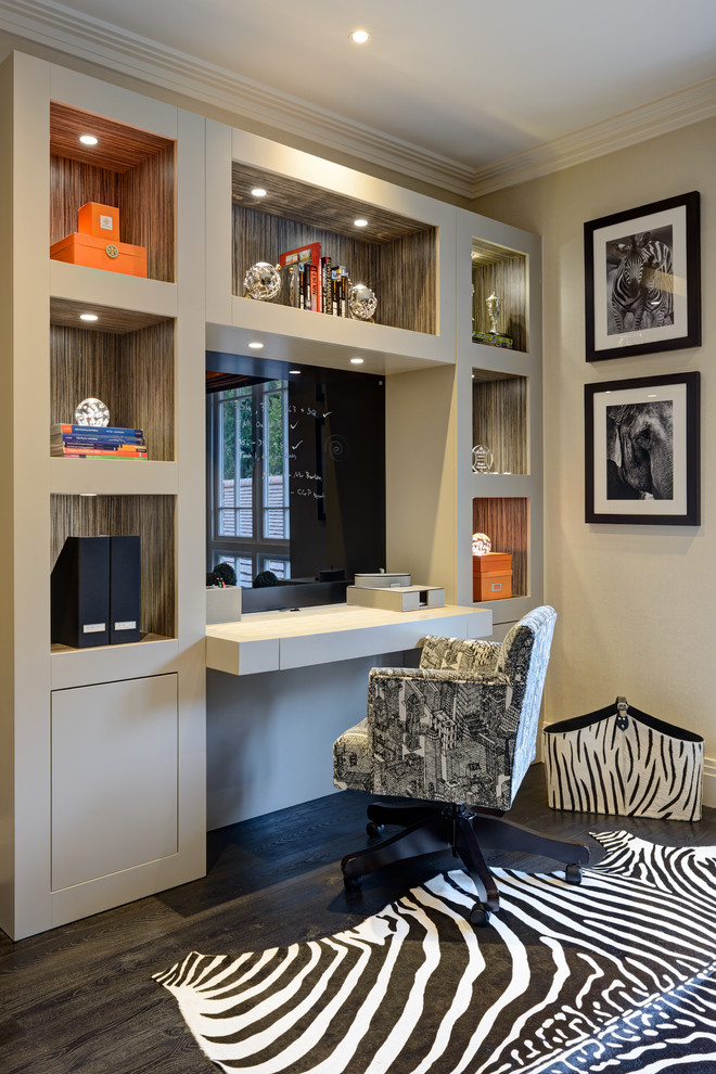 Design ideas for a mid-sized transitional home office in Surrey with beige walls, dark hardwood floors, a built-in desk and black floor.