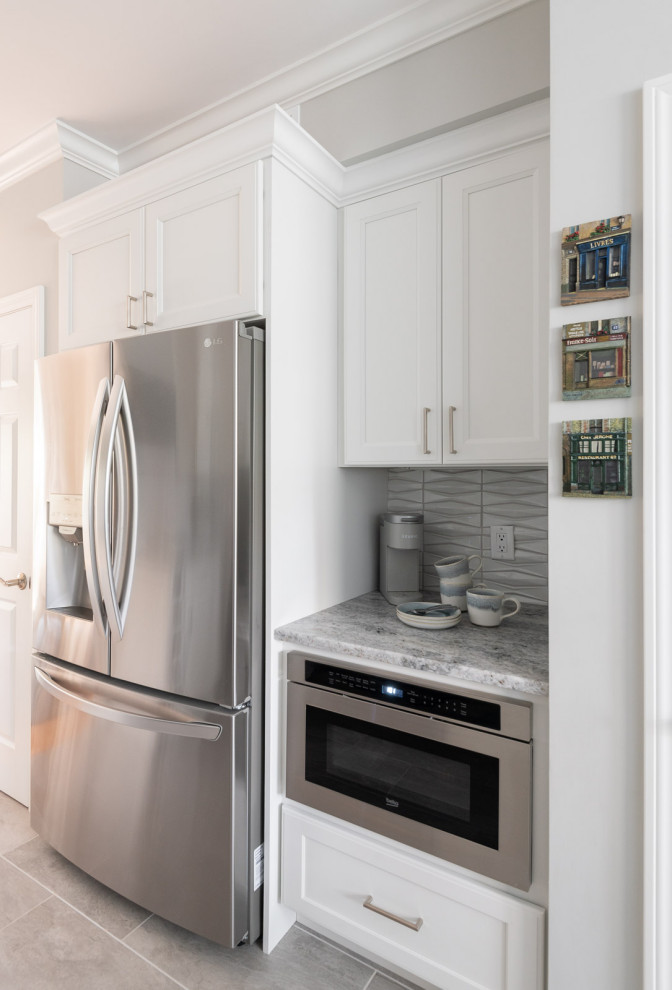Enclosed kitchen - small transitional u-shaped porcelain tile and gray floor enclosed kitchen idea in Boston with an undermount sink, shaker cabinets, white cabinets, quartz countertops, gray backsplash, ceramic backsplash, stainless steel appliances and gray countertops