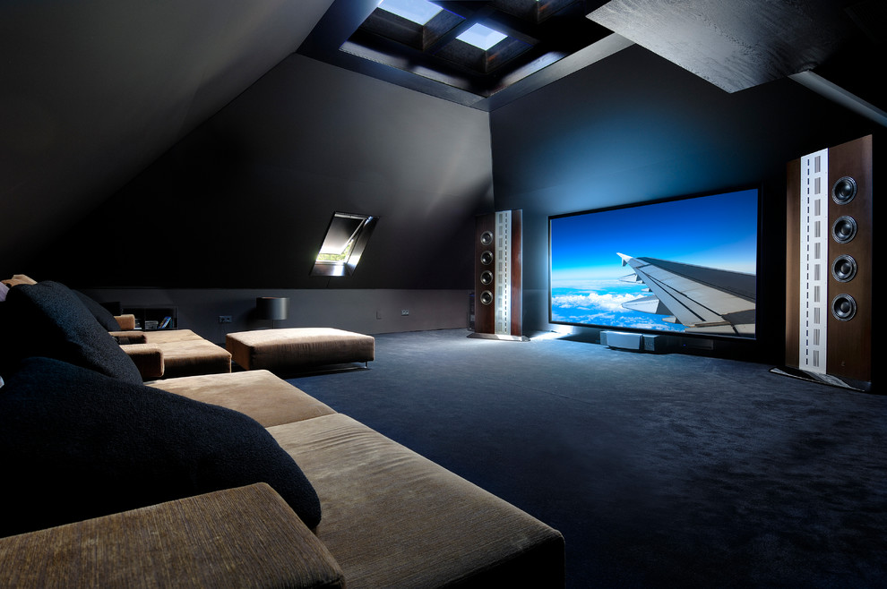 Photo of a large contemporary enclosed home theatre in Madrid with a wall-mounted tv.