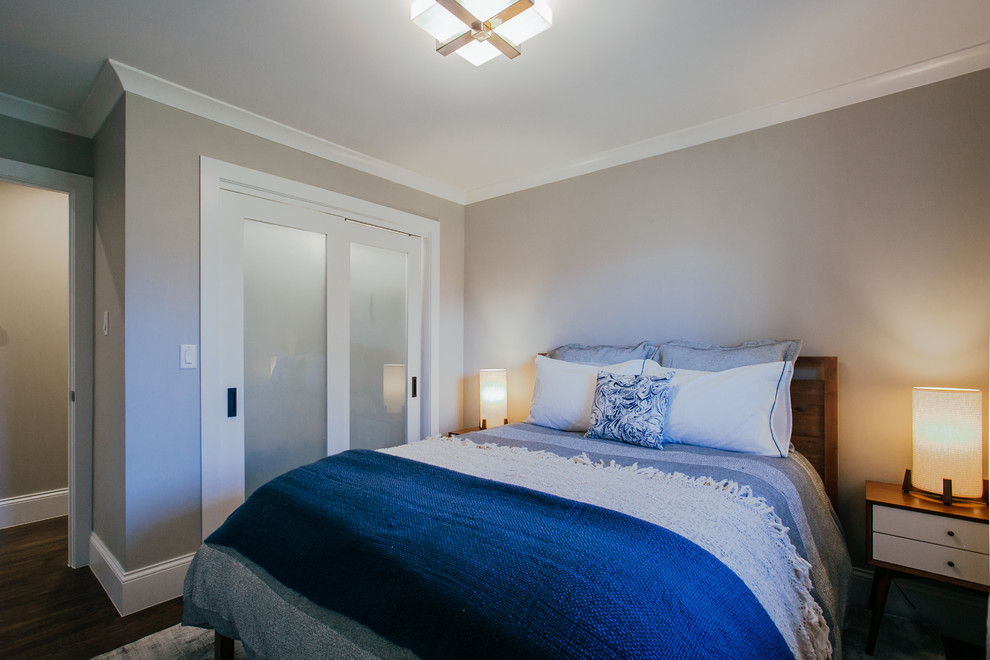Design ideas for a small transitional guest bedroom in Denver with grey walls, medium hardwood floors and brown floor.