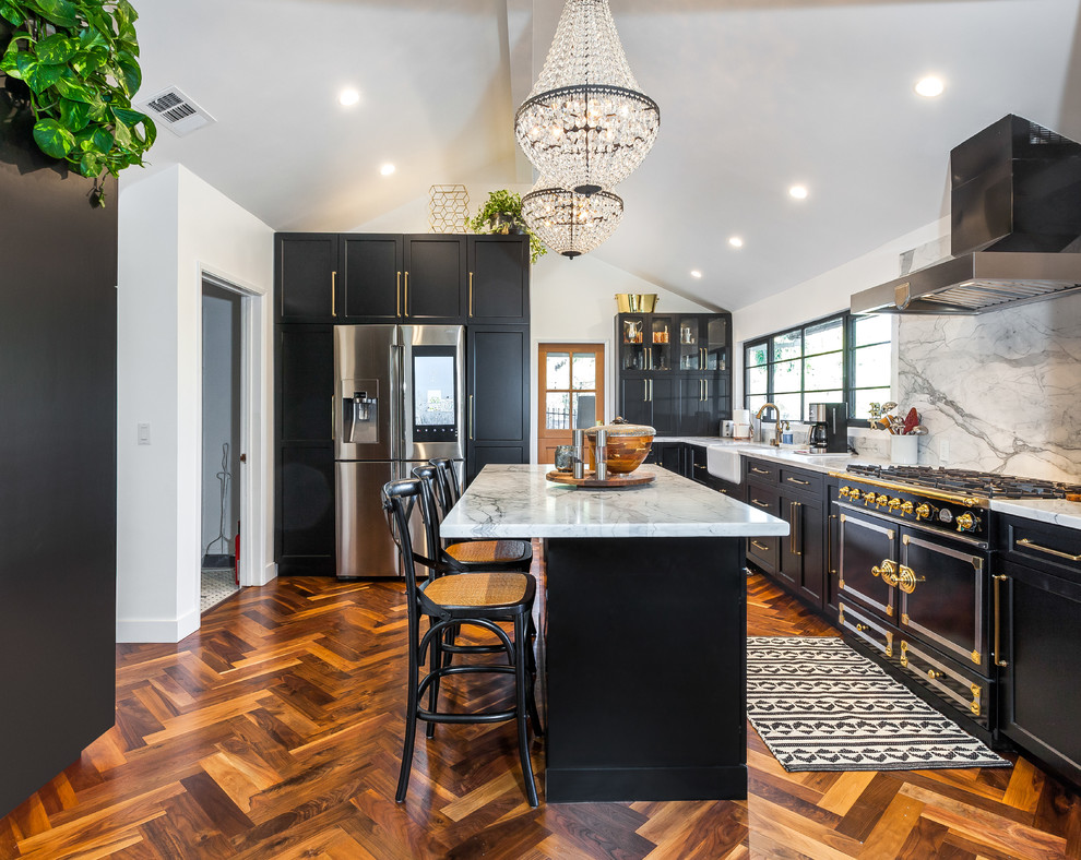 Mid-sized contemporary l-shaped eat-in kitchen in Los Angeles with an undermount sink, shaker cabinets, black cabinets, grey splashback, with island, brown floor, grey benchtop, marble benchtops, marble splashback, coloured appliances and linoleum floors.
