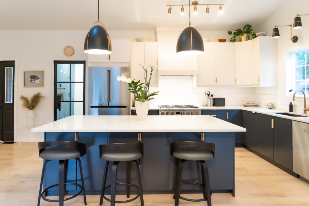 Design ideas for a large scandinavian l-shaped eat-in kitchen in Seattle with an undermount sink, flat-panel cabinets, blue cabinets, quartz benchtops, stainless steel appliances, light hardwood floors, with island, beige floor, white benchtop and vaulted.
