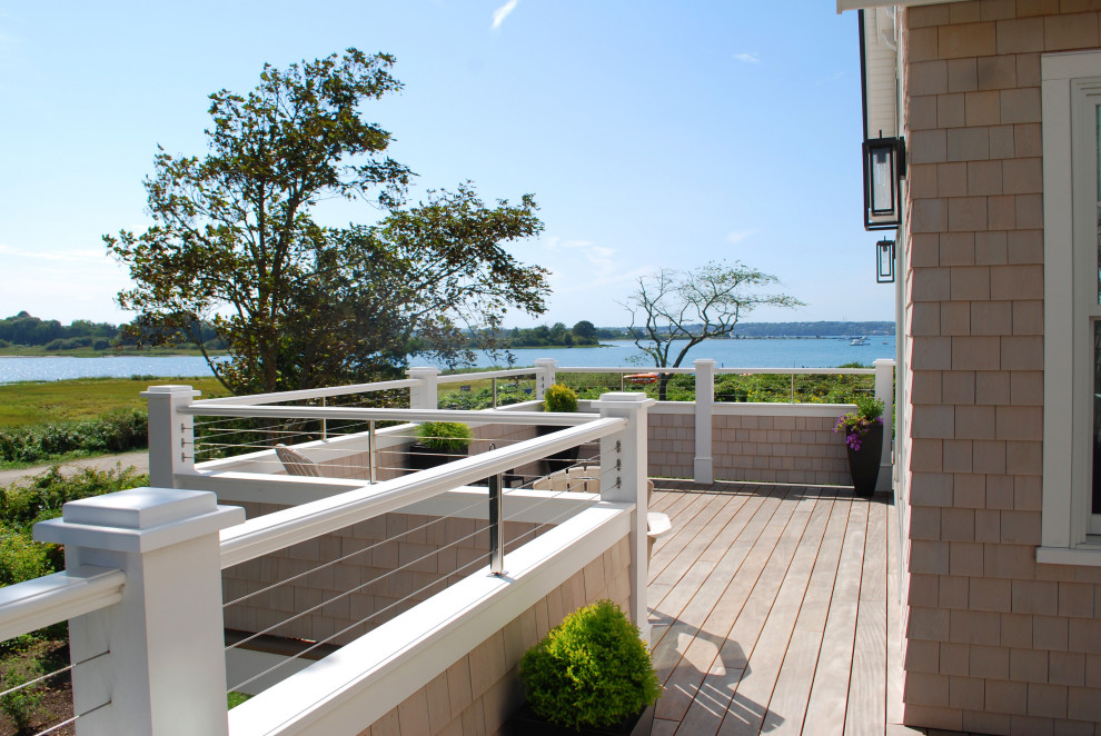 Design ideas for a large beach style side yard deck in Providence with with privacy feature and no cover.