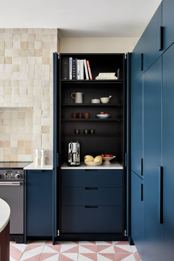 Inspiration for a large contemporary l-shaped kitchen in London with flat-panel cabinets, blue cabinets, cement tiles, with island and pink floor.