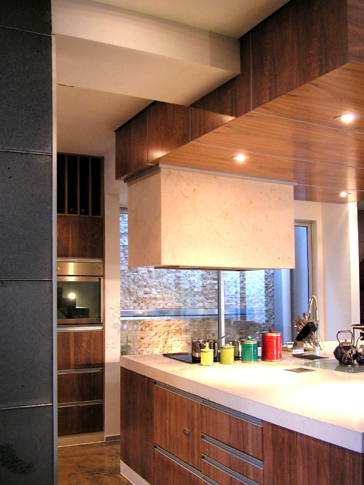 This is an example of a small galley open plan kitchen in Other with an undermount sink, quartz benchtops, concrete floors, with island, grey floor and white benchtop.