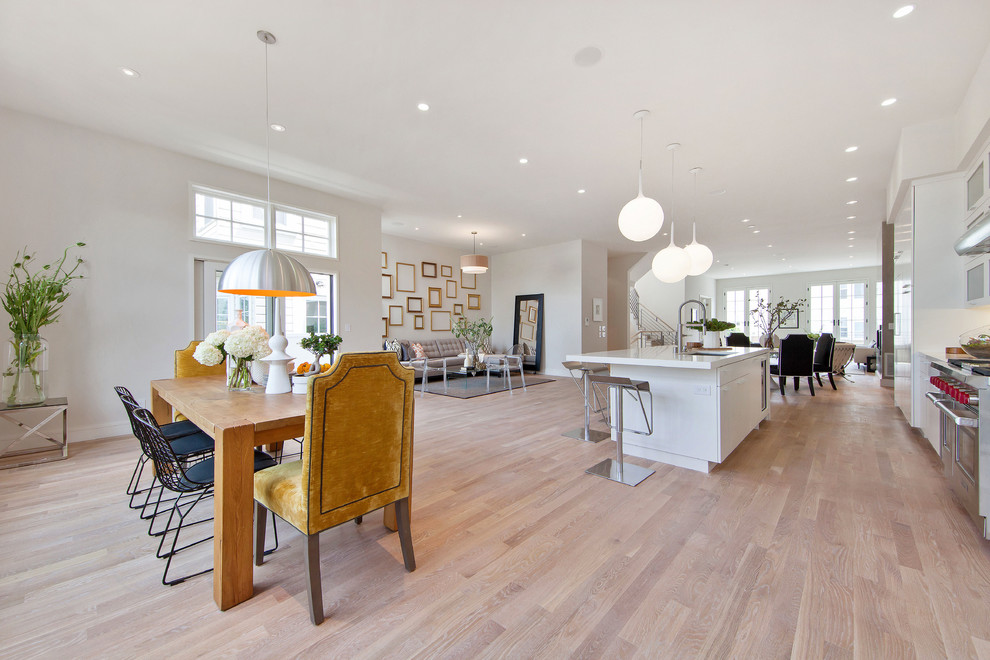 Photo of an expansive transitional open plan dining in San Francisco with white walls and light hardwood floors.