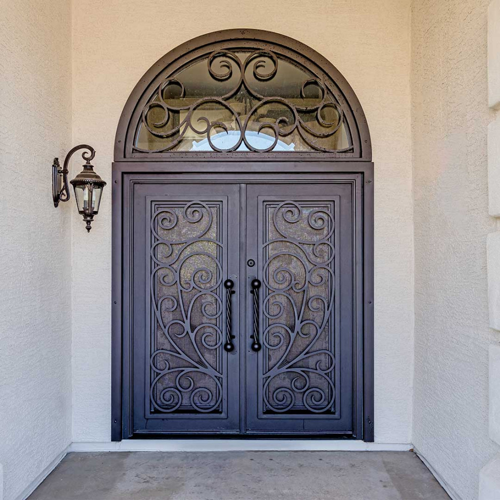 Inspiration for a mediterranean front door in Phoenix with beige walls, a double front door and a brown front door.