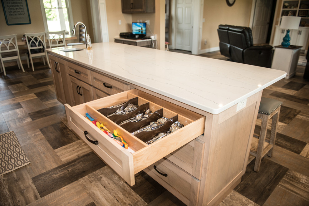 Inspiration for a large transitional l-shaped vinyl floor and multicolored floor open concept kitchen remodel with a farmhouse sink, shaker cabinets, gray cabinets, quartz countertops, white backsplash, subway tile backsplash, stainless steel appliances, an island and white countertops