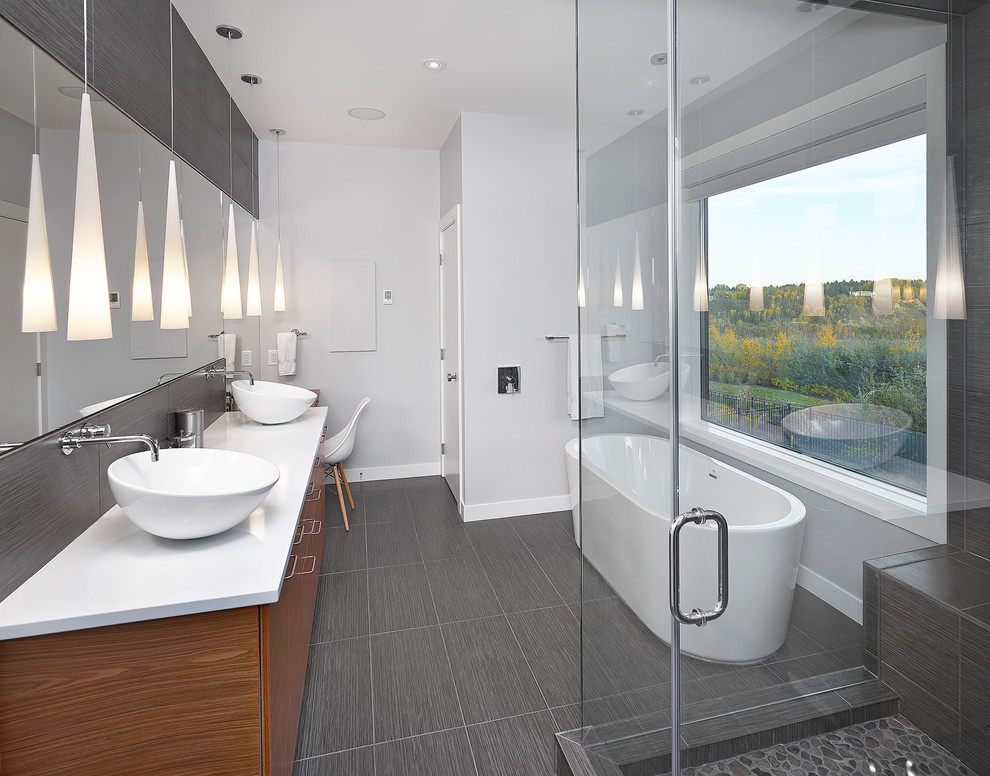 Inspiration for a contemporary bathroom in Edmonton with a vessel sink and a freestanding tub.