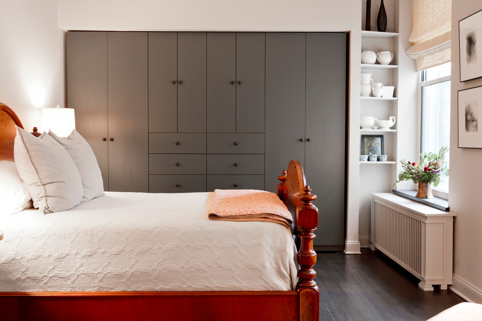 Inspiration for a small transitional bedroom in New York with dark hardwood floors and white walls.