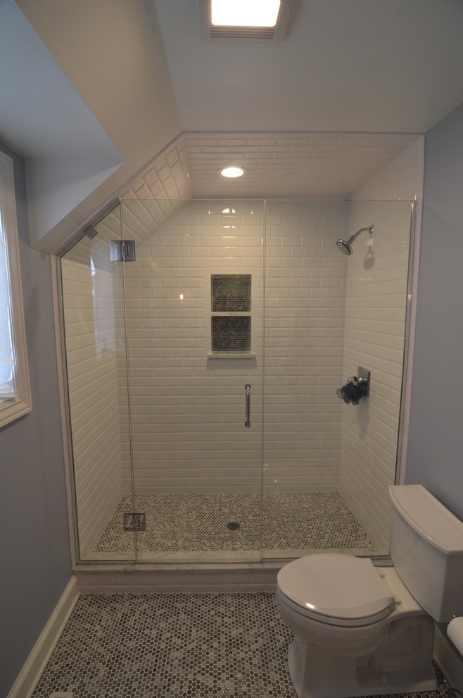 Alcove shower - mid-sized transitional kids' white tile and ceramic tile ceramic tile and gray floor alcove shower idea in Chicago with raised-panel cabinets, a two-piece toilet, blue walls, an undermount sink, quartz countertops, a hinged shower door and white cabinets