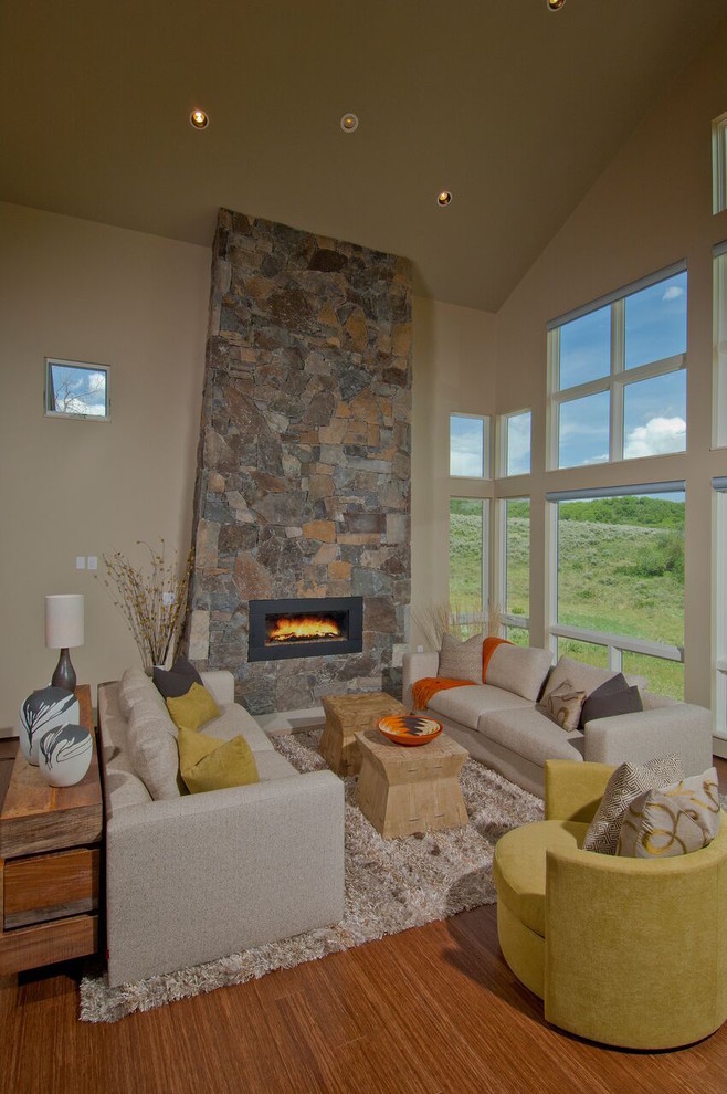Mid-sized country formal open concept living room in Denver with beige walls, medium hardwood floors, a ribbon fireplace, a stone fireplace surround and no tv.