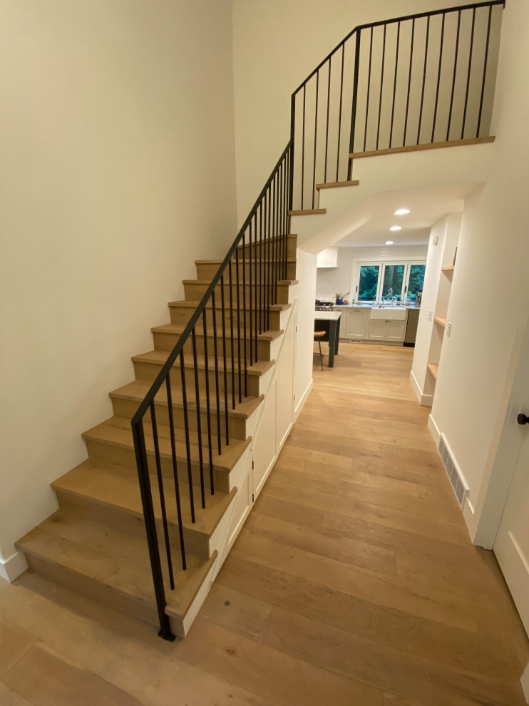 Mid-sized country wood l-shaped staircase in Seattle with wood risers and metal railing.