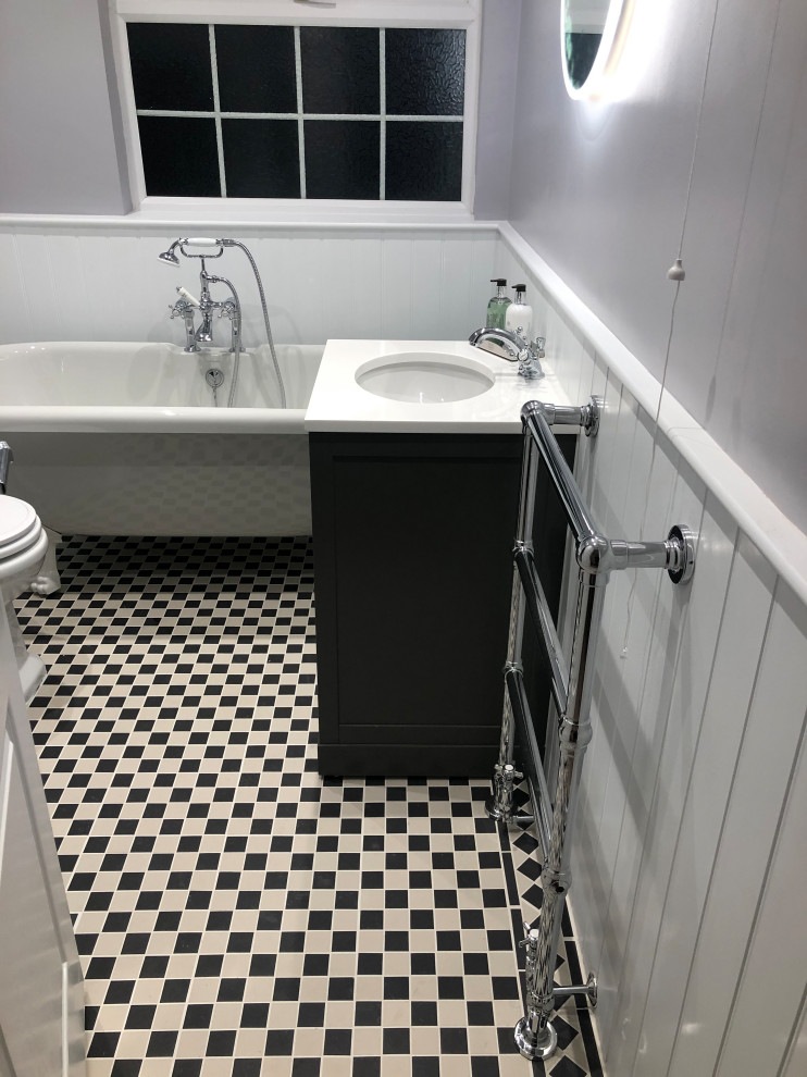 Mid-sized traditional kids bathroom in Hampshire with shaker cabinets, a freestanding tub, a two-piece toilet, mosaic tile floors, quartzite benchtops, multi-coloured floor, yellow benchtops, a freestanding vanity and planked wall panelling.