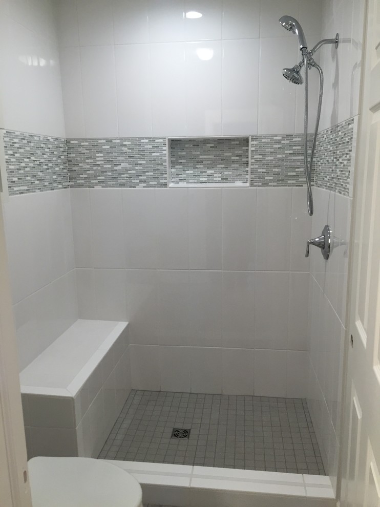 Example of a small transitional 3/4 gray tile, white tile and ceramic tile alcove shower design