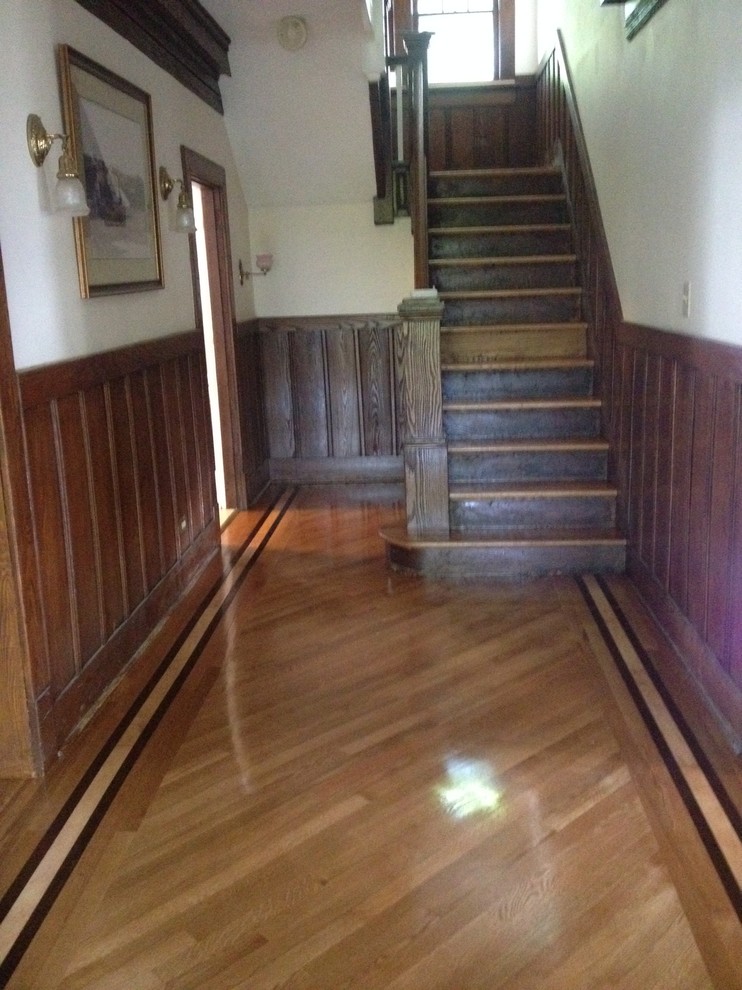 Mid-sized traditional wood curved staircase in New York with wood risers.