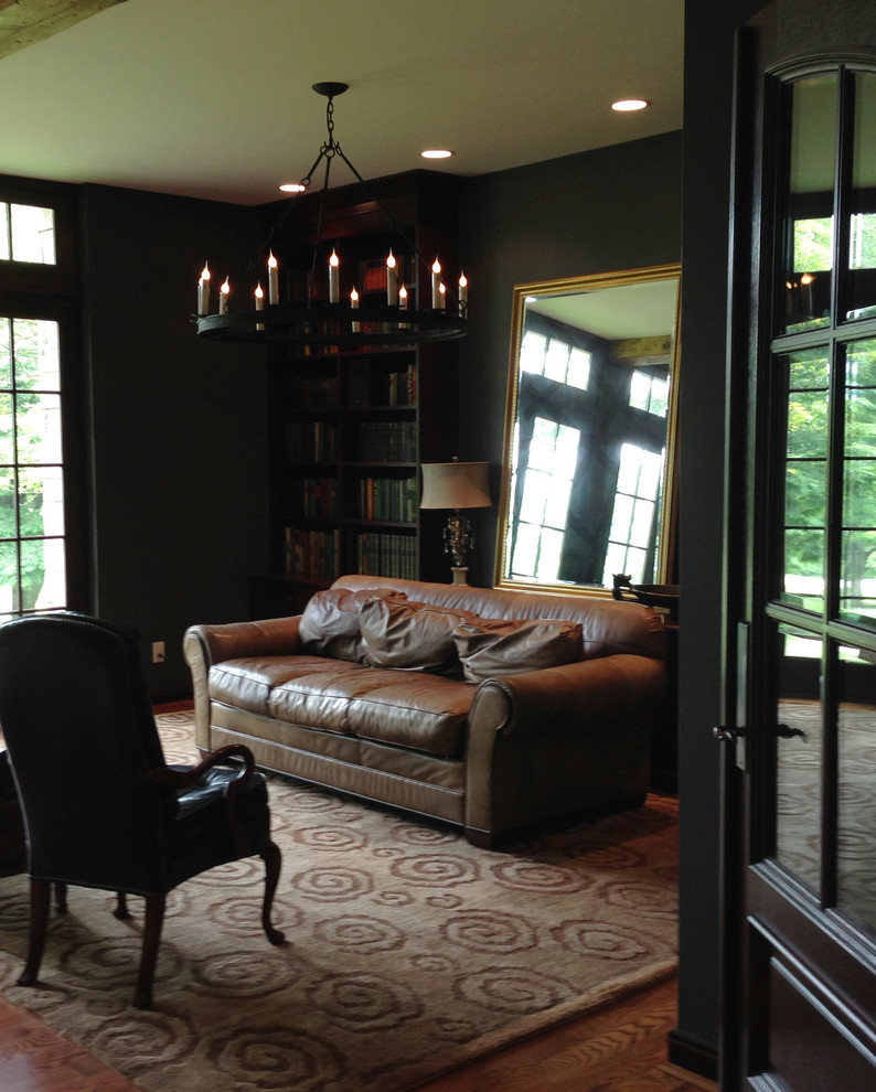Inspiration for an expansive traditional study room in Cincinnati with black walls, medium hardwood floors and a freestanding desk.