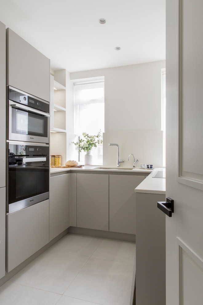 Inspiration for a small contemporary u-shaped kitchen in London with an undermount sink, flat-panel cabinets, grey cabinets, no island and grey floor.