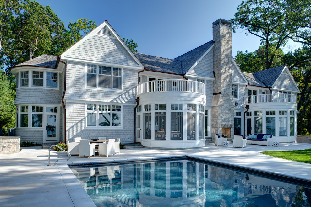 Design ideas for a beach style two-storey white exterior in Chicago with wood siding.