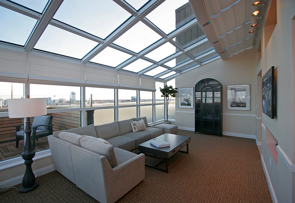 Inspiration for a large transitional sunroom in New York with carpet, a two-sided fireplace, a skylight and brown floor.