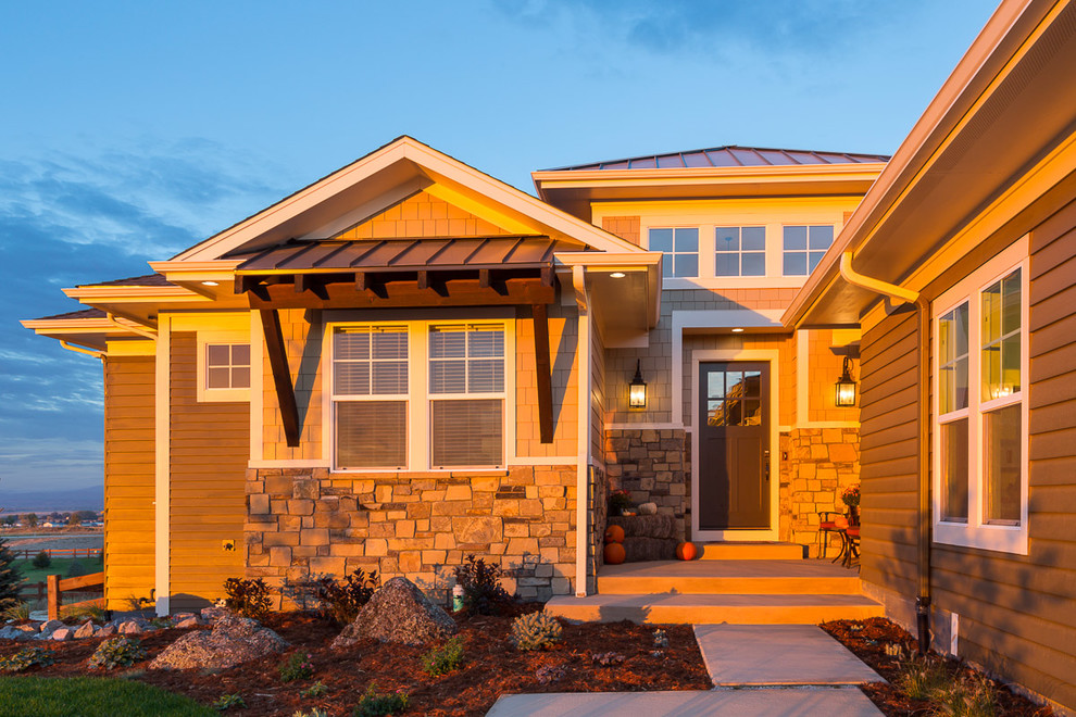 Inspiration for a large transitional two-storey brown exterior in Denver with mixed siding and a hip roof.