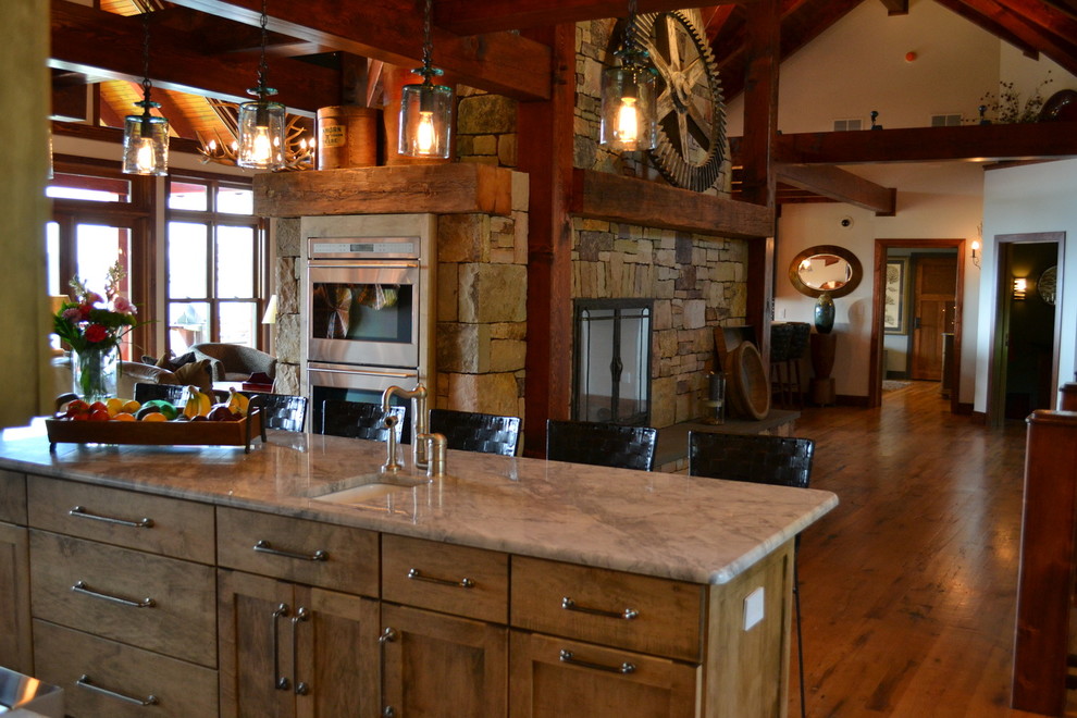 Inspiration for a large rustic single-wall medium tone wood floor open concept kitchen remodel with an undermount sink, stainless steel appliances, multicolored backsplash, matchstick tile backsplash, shaker cabinets, medium tone wood cabinets, granite countertops and an island