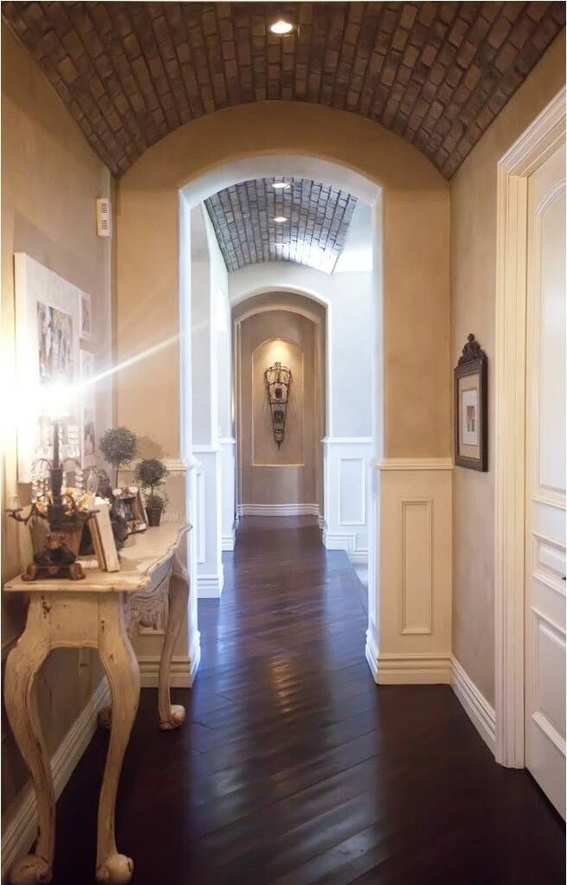 Example of a mid-sized transitional dark wood floor and brown floor hallway design in Phoenix with beige walls