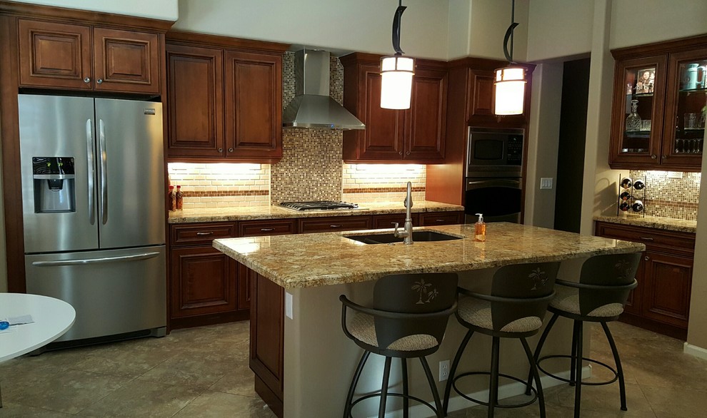 Eat-in kitchen - transitional single-wall eat-in kitchen idea in Phoenix with an undermount sink, dark wood cabinets, granite countertops, brown backsplash, glass tile backsplash, stainless steel appliances and an island