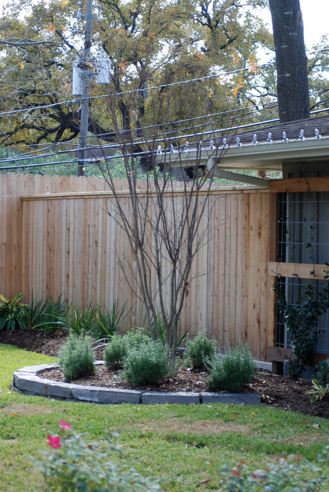 Inspiration for an expansive midcentury backyard partial sun garden in Houston.