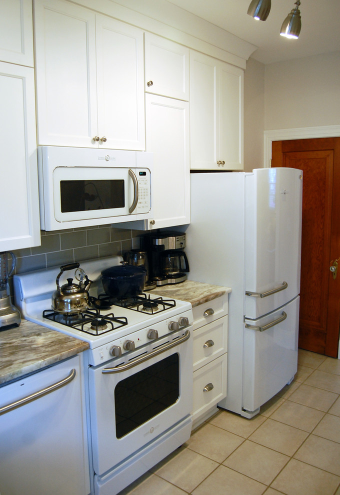 Small transitional kitchen photo in Baltimore with a drop-in sink, flat-panel cabinets, white cabinets and an island