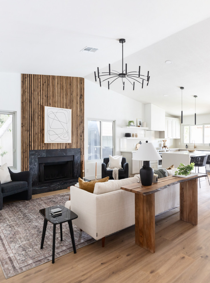 Inspiration for a small modern open concept laminate floor, brown floor, vaulted ceiling and wood wall living room remodel in Phoenix with a standard fireplace
