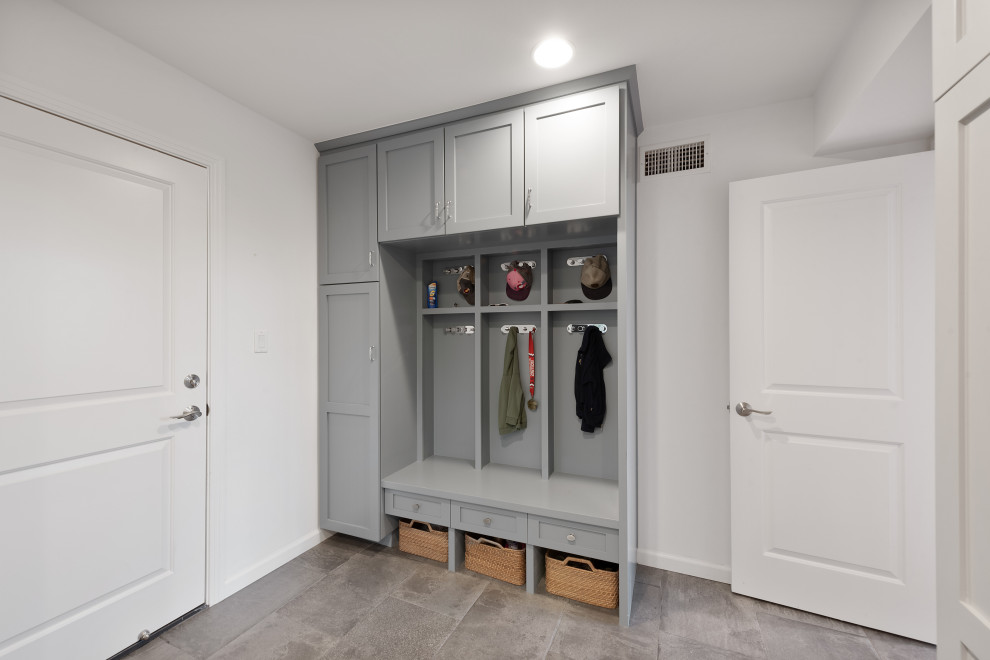 This is an example of an expansive transitional u-shaped utility room in Los Angeles with an undermount sink, shaker cabinets, grey cabinets, quartzite benchtops, white walls, ceramic floors, a side-by-side washer and dryer, beige floor and grey benchtop.