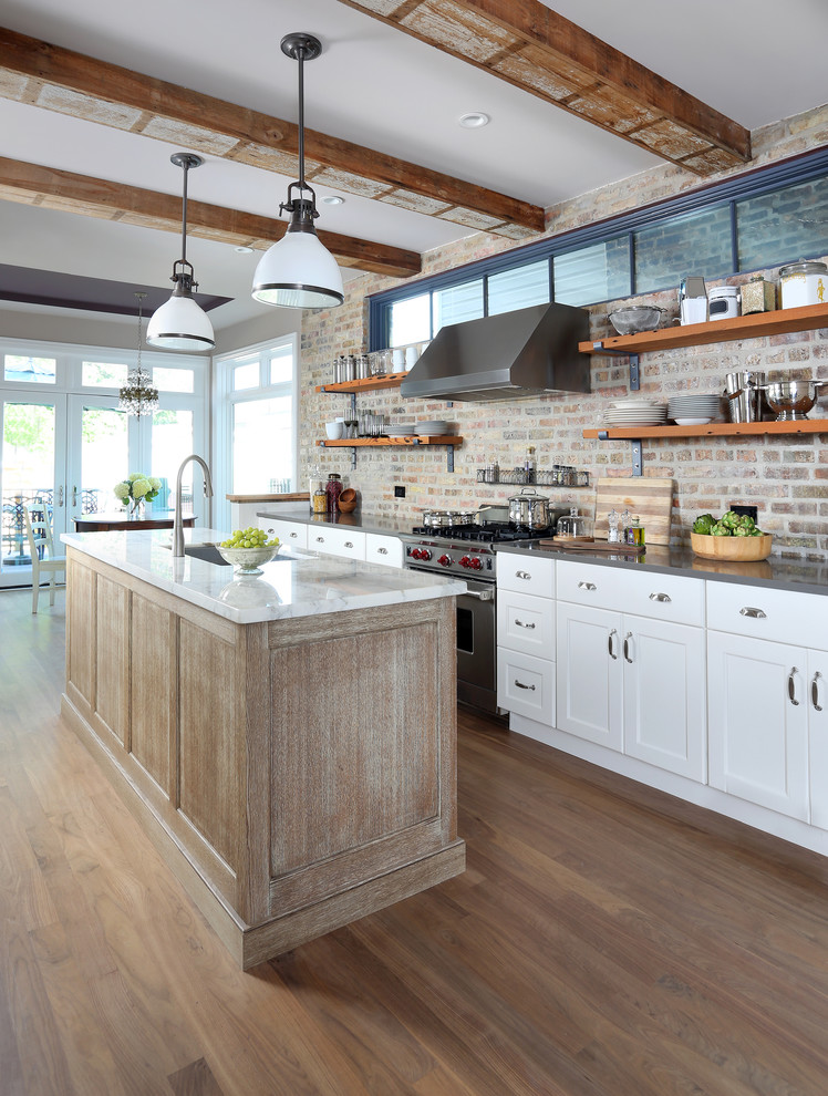 Example of a large eclectic galley medium tone wood floor eat-in kitchen design in Chicago with flat-panel cabinets, an island, an undermount sink, white cabinets, quartz countertops, brown backsplash and stainless steel appliances