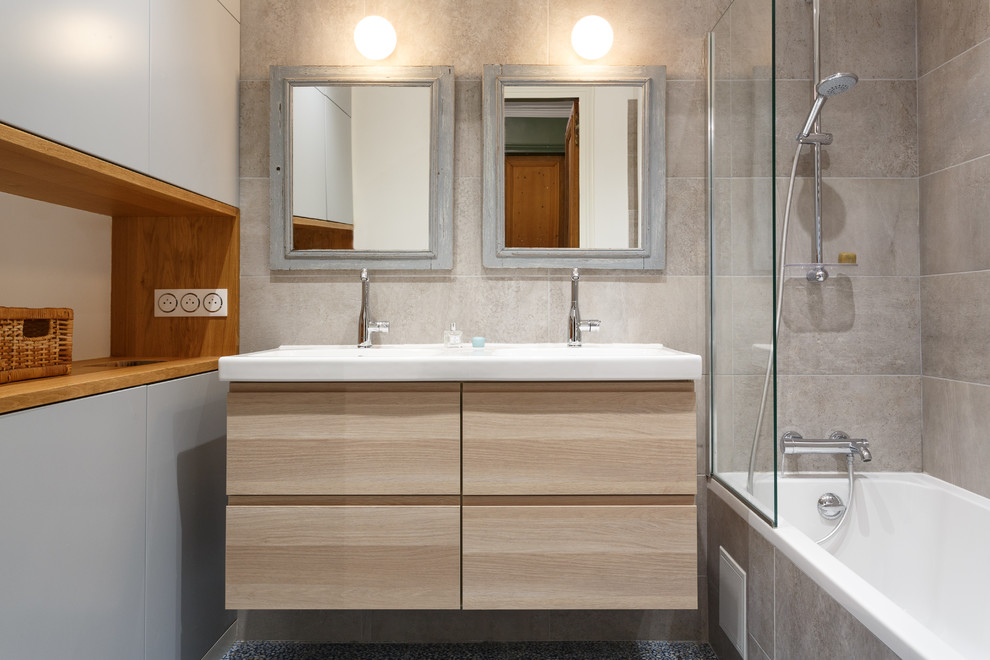 Photo of a small modern master bathroom in Paris with flat-panel cabinets, beige cabinets, an undermount tub, a shower/bathtub combo, a two-piece toilet, gray tile, ceramic tile, grey walls, terrazzo floors, a console sink, solid surface benchtops, blue floor and white benchtops.
