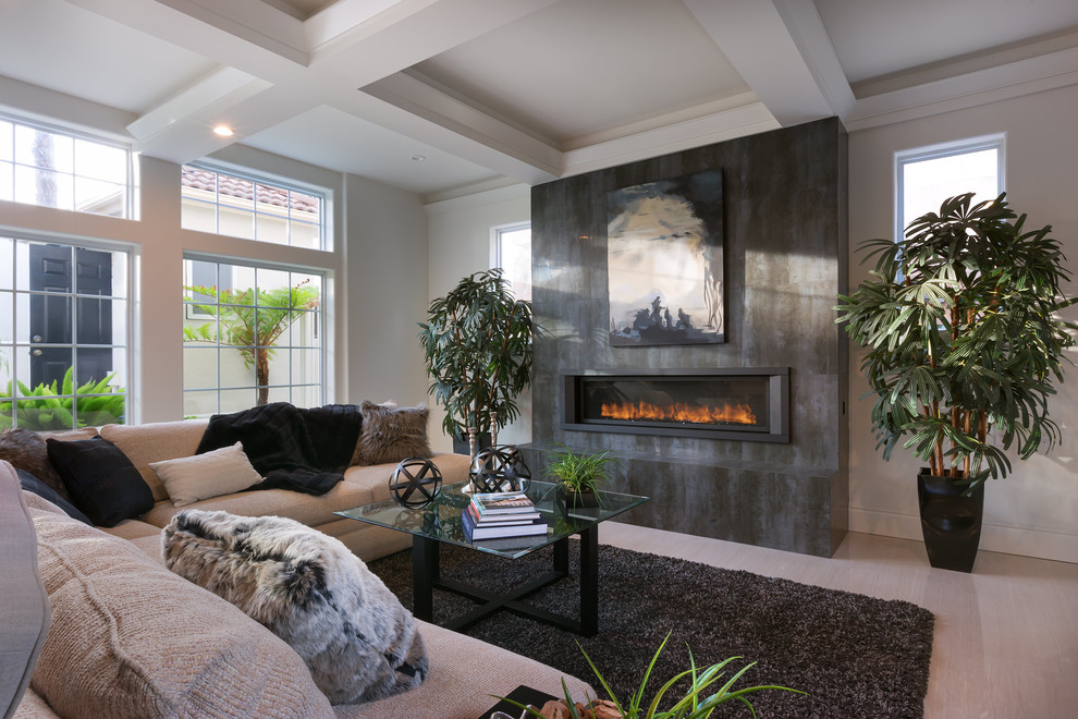 Photo of a large contemporary formal living room in Los Angeles with white walls, porcelain floors, a ribbon fireplace, a stone fireplace surround, no tv and beige floor.