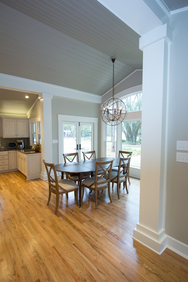 This is an example of a mid-sized country open plan dining in Atlanta with grey walls and light hardwood floors.