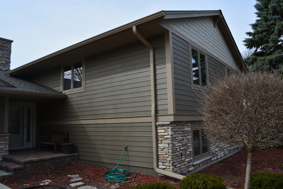 This is an example of an arts and crafts exterior in Minneapolis with concrete fiberboard siding.