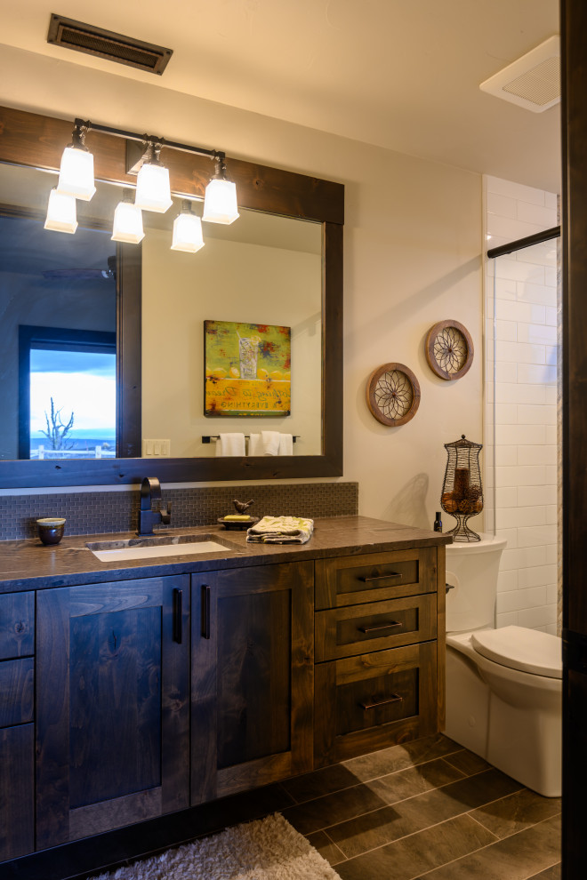 This is an example of a country kids bathroom with shaker cabinets and a floating vanity.