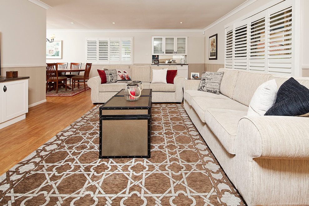 This is an example of a mid-sized country open concept living room in Gold Coast - Tweed with beige walls.