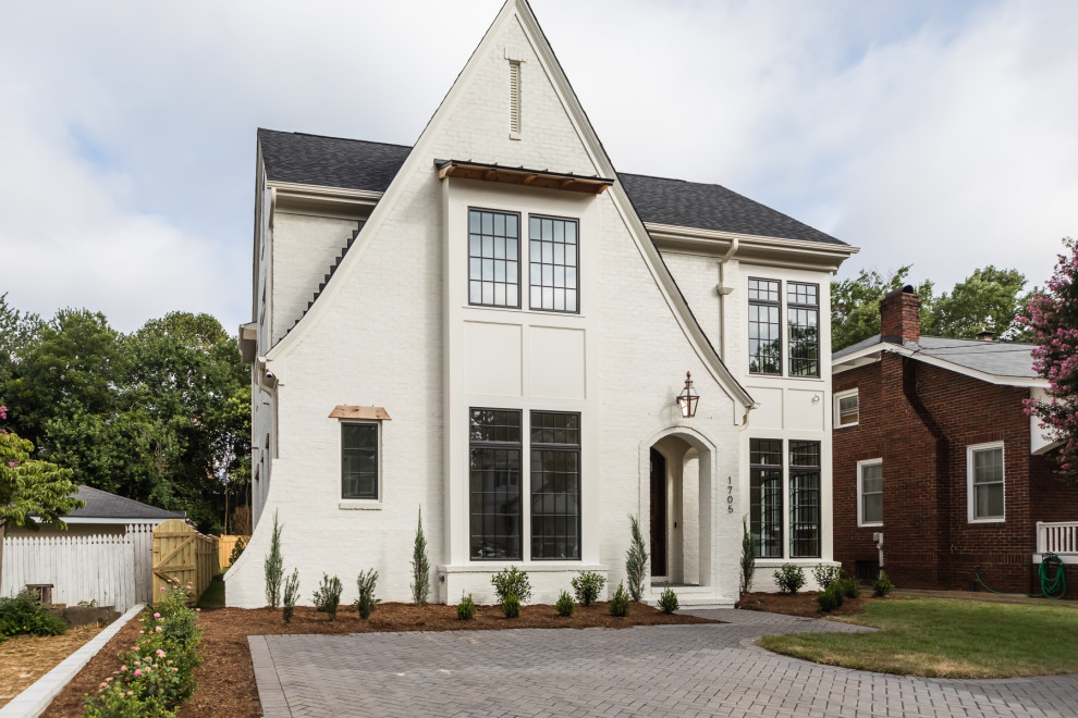 Design ideas for a transitional two-storey brick white house exterior in Raleigh with a gable roof, a shingle roof and a grey roof.