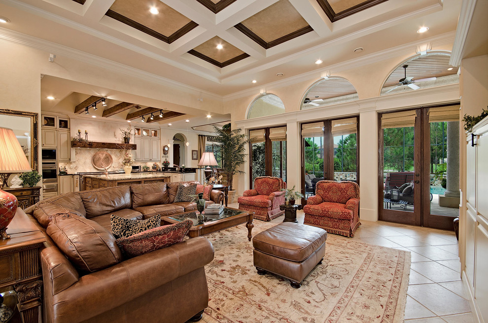 This is an example of a traditional open concept living room in Miami with beige walls and a built-in media wall.