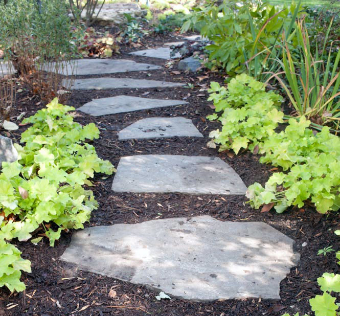 Photo of a small rustic partial sun side yard stone landscaping in Chicago.