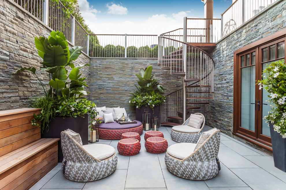 Design ideas for a contemporary courtyard patio in New York with no cover, concrete pavers and a container garden.