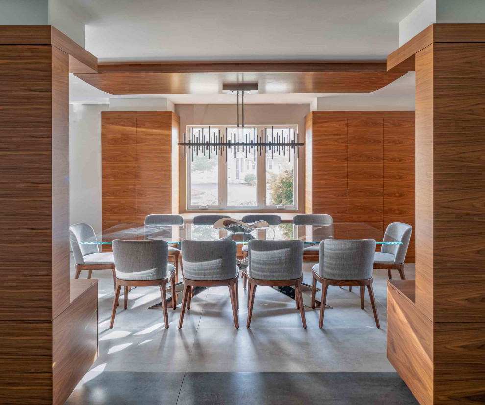 Contemporary dining room in Boston with grey walls, grey floor and wood.
