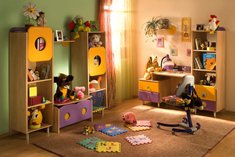 Photo of a small modern gender-neutral kids' playroom in Miami with light hardwood floors and multi-coloured walls.