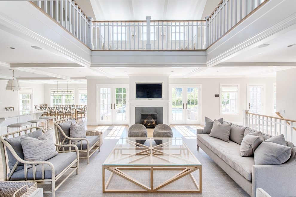 Lower Cliff Rd. - Example of a huge beach style open concept family room design in Boston with a stone fireplace, a wall-mounted tv and a standard fireplace