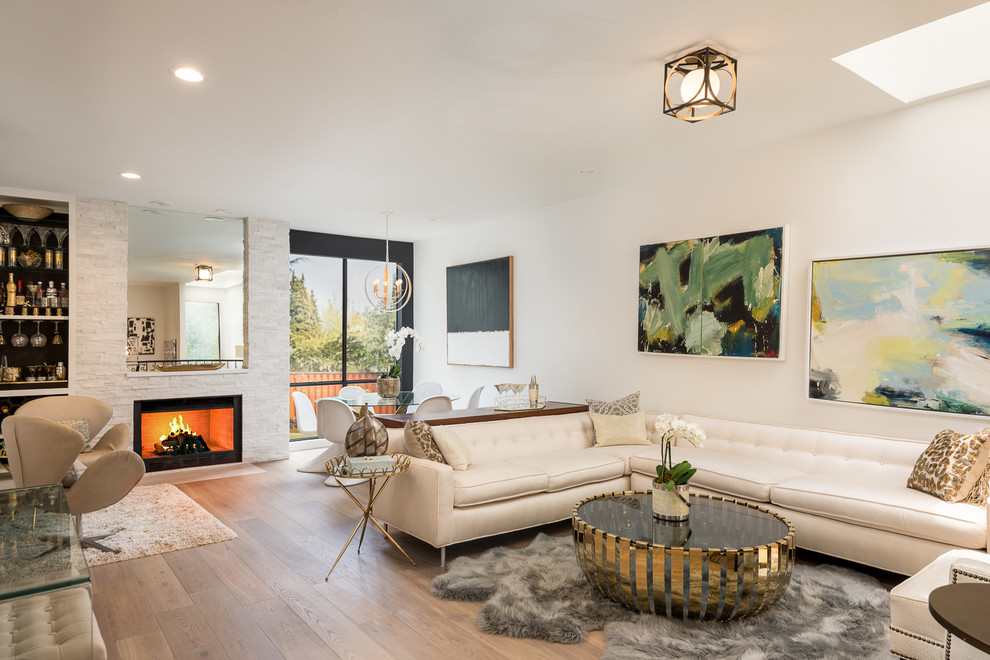 Inspiration for a large contemporary open concept living room in Dallas with white walls, medium hardwood floors, brown floor, a standard fireplace and a stone fireplace surround.